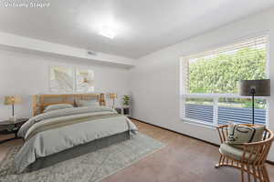 Bedroom with light carpet and baseboards