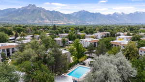 Drone / aerial view of a mountain backdrop and a pool area