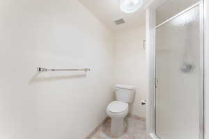 Bathroom featuring a stall shower and tile patterned flooring