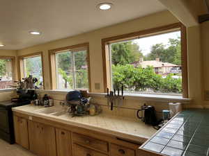 Kitchen featuring black electric range oven, healthy amount of natural light, tile counters, and recessed lighting