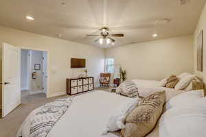 Bedroom with light colored carpet, recessed lighting, and a ceiling fan