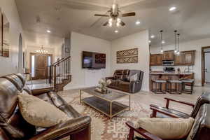 Living area featuring a ceiling fan, light wood-style flooring, recessed lighting, stairway, and arched walkways