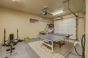 Garage with a garage door opener and baseboards