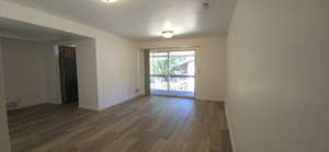 Empty room with baseboards and wood finished floors