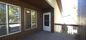 Property entrance with a balcony