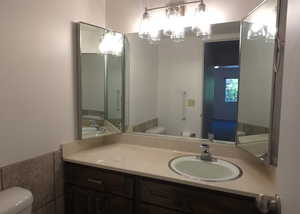 Bathroom featuring vanity and a chandelier