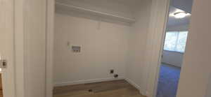 Laundry room with hookup for a washing machine, wood finished floors, and hookup for an electric dryer