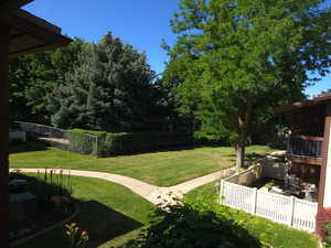 View of yard with a balcony