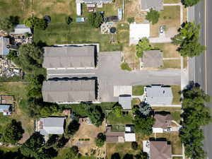 Aerial view of property and surrounding area with nearby suburban area