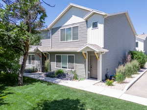 View of front of South Fiv-Plex East unit  featuring a front lawn and landscape.