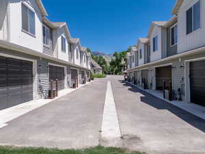 View of two car garages between North and South Five Plex'.  Asphalt road with a mountain view.