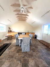 Dining space featuring track lighting, lofted ceiling, and a ceiling fan
