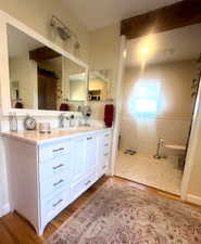 Bathroom with wood finished floors and vanity