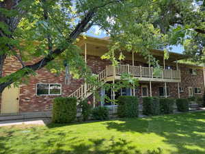 Rear view of property featuring deck