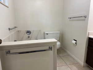 Bathroom with vanity, tile patterned floors, and a bathtub
