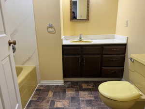 Full bathroom featuring vanity and stone finish flooring