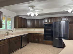 Kitchen featuring appliances with stainless steel finishes, ceiling fan, light countertops, and light tile patterned floors
