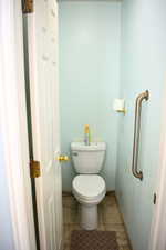 Bathroom with toilet and baseboards