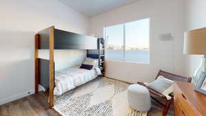 Bedroom featuring wood finished floors and baseboards