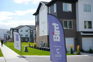 View of building exterior featuring a garage and a residential view