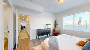 Bedroom with light wood-type flooring and baseboards