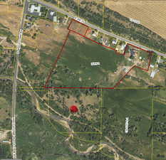 Aerial overview of property's location with property parcel outlined in yellow.