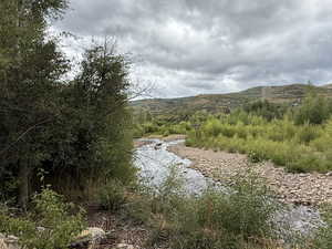 Surrounded by tall trees and mountains on all sides