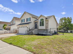Tri-level home featuring fenced yard, large lot, full auto sprinkler system.