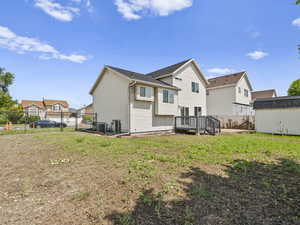 Rear view of property with a wooden deck, a residential view, and a storage shed