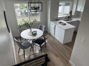 Dining area w LVP floors, new cabinets and stainless steel appliances. and healthy amount of natural light