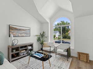 Living area with new LVP floors and vaulted ceiling