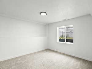 Carpeted spare room with baseboards