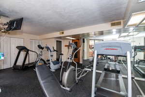 Workout area featuring a textured ceiling
