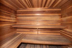 Sauna / steam room featuring wooden ceiling and wooden walls