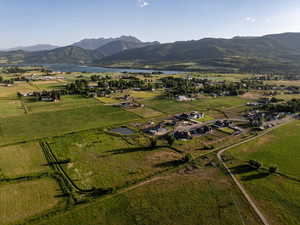 Aerial view of property and surrounding area featuring a water and mountain view