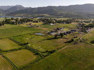 Aerial overview of property's location with a water and mountain view and rural landscape