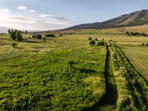View of mountain backdrop featuring rural landscape