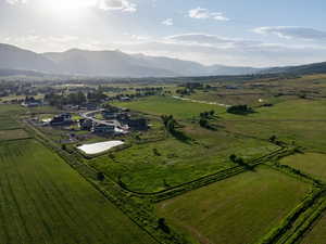 Aerial view of property's location featuring rural landscape and a mountainous background