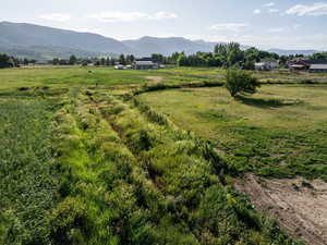View of mountain backdrop featuring rural landscape
