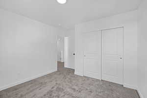Unfurnished bedroom with carpet floors and a closet