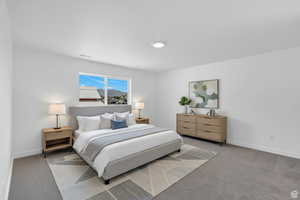 Bedroom featuring carpet and baseboards