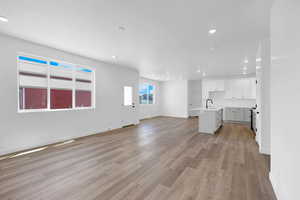 Unfurnished living room with recessed lighting and light wood-type flooring