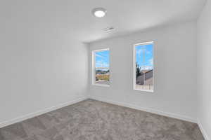 Unfurnished room with carpet and a textured ceiling