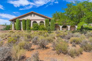 View of front of property featuring stucco siding and a tiled roof