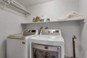 Laundry room with washing machine and clothes dryer