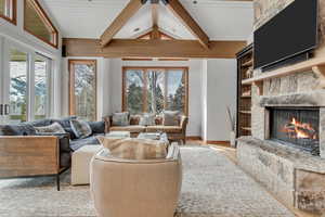 Living area with a fireplace and light wood-style flooring