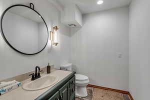Half bath featuring vanity and recessed lighting