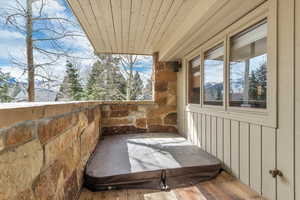 View of patio featuring a covered hot tub