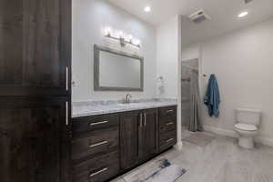 Full bath with vanity, a shower with shower curtain, and recessed lighting