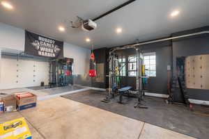 Garage featuring a garage door opener and recessed lighting